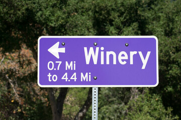 Winery road sign with arrow and distance in miles directs visitors to nearby wineries