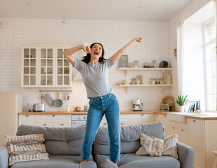 woman jumping on the sofa