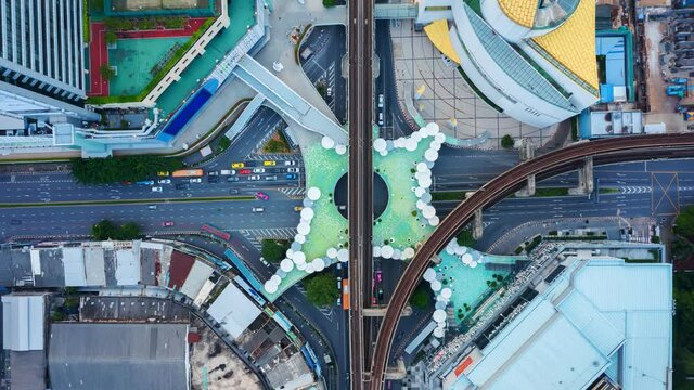 Time lapse of aerial view of Siam Bangkok Art and Skywalk aerial view in MBK Culture Center intersection or junction with cars traffic skyscraper buildings. Bangkok City in downtown at night, Thailand