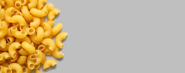 Macaroni Pasta on Gray Background, Copy Space for Text, Food Background Concept.