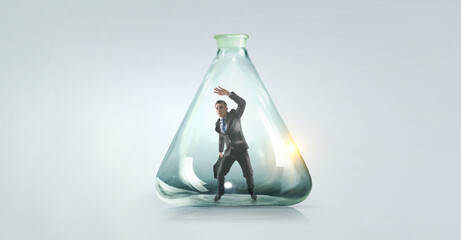 Businessmen scared inside glass bottle