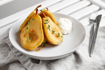 caramelized pears in a plate of ice cream on a napkin on a chair close-up
