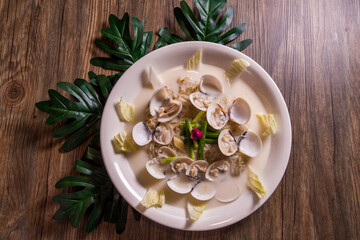 braised stew fresh seafood clam shell hot soup with cream milk in plate on wood table asian halal menu