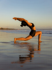 Sunset beach yoga. Anjaneyasana, Low Lunge Pose. Crescent Moon Pose. Lunging back bending asana....