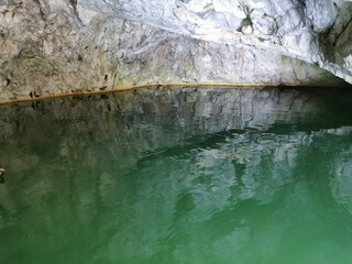The wall of the grotto, reflected in the emerald water of the Marble Canyon in the Ruskeala Mountain Park.