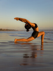 Sunset beach yoga. Anjaneyasana, Low Lunge Pose. Crescent Moon Pose. Lunging back bending asana....