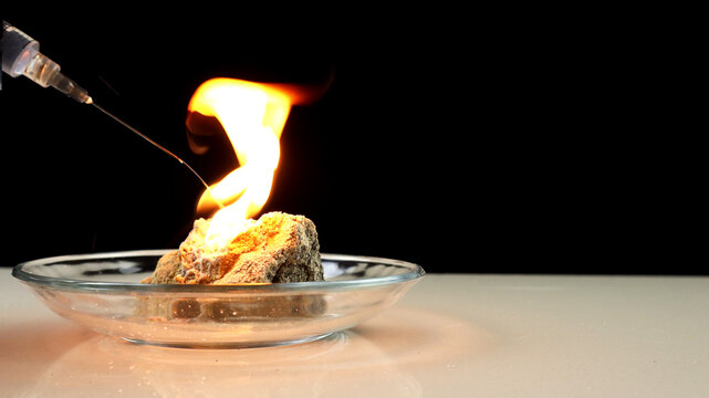 Calcium carbide or CaC2 reacts on contact with water and produces flammable acetylene gas. A fire created by burning acetylene gas