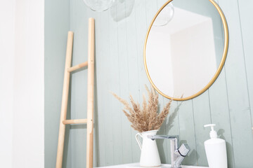 A modern bathroom interior with a minimalist decor, a sink and a round mirror in a stylish bathroom. Interior design. High quality photo