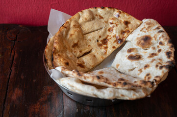 Homemade Roti (or Chapati) served on table. Roti is made of whole wheat flour and is eaten in India with dal and curries. Roti is an integral part of Indian cuisine.