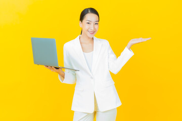 Portrait beautiful young asian woman smile with computer laptop