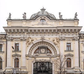 Fototapeta na wymiar Luxurious building in the Baroque style, Firsanova's apartment house, Neglinnaya street 14, Moscow, Russia. Facade of a 18th century building with gate, clock and stucco decoration.