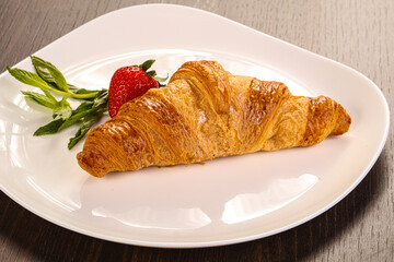 Sweet croissant in the plate