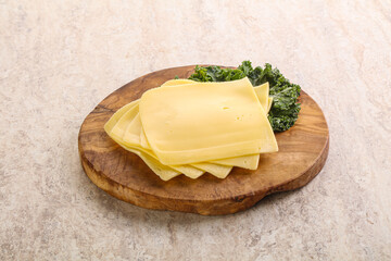 Sliced Gouda cheese over board