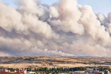 Dark and dense smoke clouds from a fire in Spain. Close-up of a large smoke cloud in the sky from a forest fire