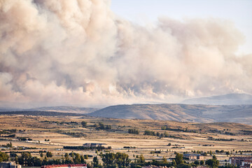 Dark and dense smoke clouds from a fire in Spain. Close-up of a large smoke cloud in the sky from a forest fire