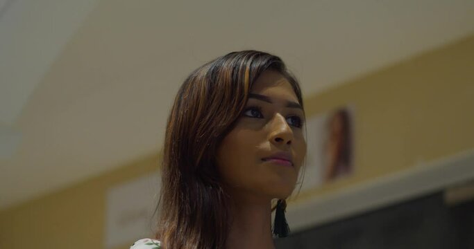 facial closeup of a young woman confidently walking at a Mall