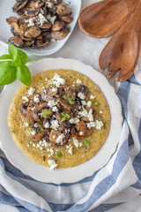 Traditional polenta with mushrooms and cheese on a plate