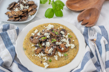 Traditional polenta with mushrooms and cheese on a plate