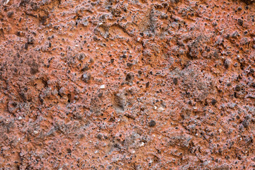 Pale orange plaster on exterior cement wall with small stones. Background snd Wallpaper textured picture. top view. Paints and varnishes. Nobody. Copy and test space. Aged wall pattern. Construction