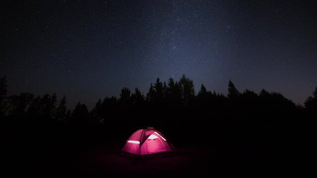 4k timelapse with tent under starry night sky.