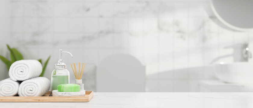 White Marble Table Top With Hand Towels, Soap, Shampoo, Aroma Diffuser And Mockup Space Over Bathroom Interior, 3d Rendering