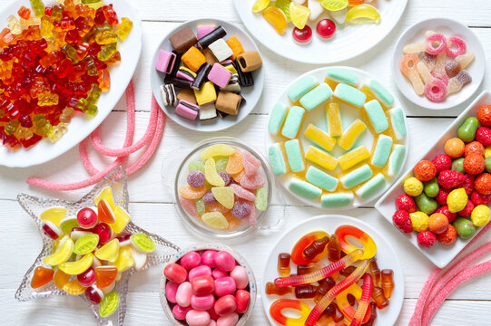 Assorted of different colorful chewy candies with fruit flavors, top view, flat lay.