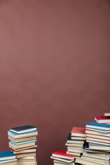 Stacks of books for teaching knowledge university library brown background