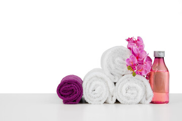 Fototapeta na wymiar Spa composition with towels and flowers isolated on white