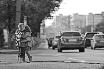 children cross the road / boy and girl small children in the city at the crossroads, car, transport