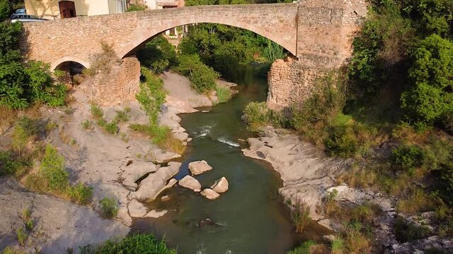 River Flows Over Brick Stone Bridge At The Village Near Jerica In Castellon Province Of Valencian Community, Spain. - Long Shot