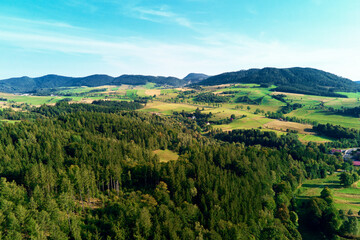 Mountains and green fields, aerial view. Panorama of beautiful landscape