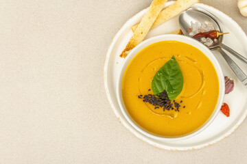 Pumpkin cream soup. Traditional autumn food. Hot dish, ripe vegetables, fragrant spices