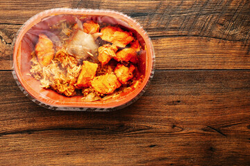 Chicken jalfrezi dish in a plastic bowl