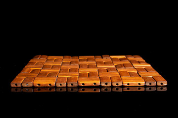 Bamboo coaster isolated on black glass