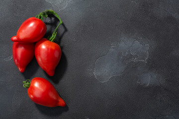 Korean  pepperlike vine tomatoes (Solanum lycopersicum fruits) in cluster, top view, copy space