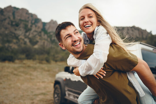 Young couple is on romantic trip to the mountains by car