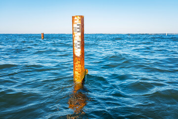 Water depth measurement tool or sea level marker. Observation of the water level scale to prevent floods and disasters