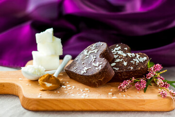 on the table there are handmade chocolates made of coconut oil, coconut chips and cocoa. dessert...