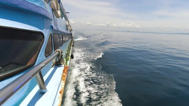 Water Spray from a Ferry Crossing to Koh Phi Phi from Krabi in Thailand Panning Up to Horizon View of the Open Waters.