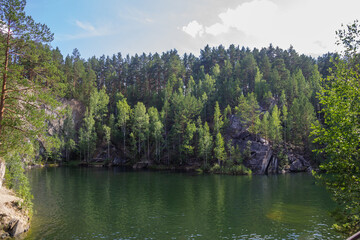 Fototapeta na wymiar Lake in the forest among the rocks