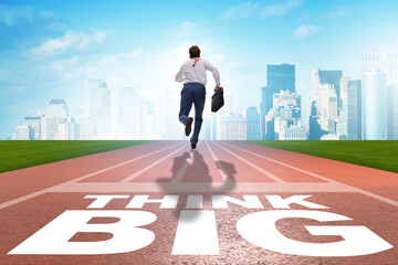 Businessman in think big concept on running track