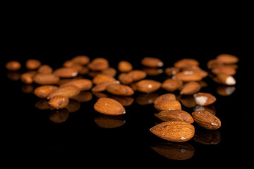 Lot of whole almond on black glass