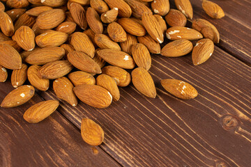 Lot of whole almond on brown wood