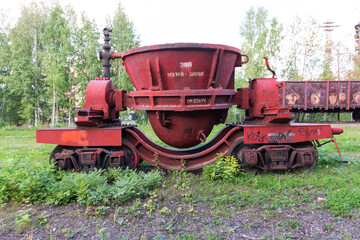 red trolley with a container on rails