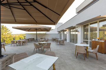 Empty terrace hotel restaurant with sun shades