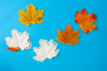 Maple leaf with painted face as decoration for autumn Halloween holiday celebration. Halloween...