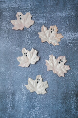 Maple leaf with painted face as decoration for autumn Halloween holiday celebration. Halloween...