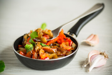 fried eggplants with peppers, tomatoes, onions and garlic