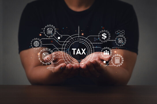 A businessman using a computer fills out a personal income tax return form online for tax payments. state tax government with chart and graph icons on a digital screen interface