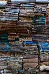 Venice, Italia - August 04 - 2021 Background wallpaper of ancient books piled on top of each other. Ancient bookshop in Venice with all books stacked one on top of the other, ruined by time.